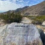 Shiprock historical marker in Palm Springs, California, with desert mountains in the background