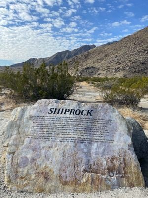 Shiprock historical marker in Palm Springs, California, with desert mountains in the background