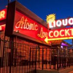Atomic Liquors Las Vegas glowing neon signs at night highlighting cocktails and liquor.