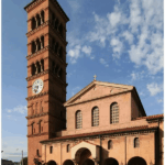 Exterior view of St. Andrew’s Catholic Church in Pasadena, California, featuring Romanesque architecture and clock tower.