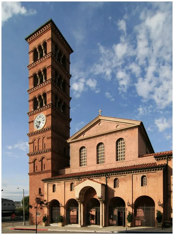 Exterior view of St. Andrew’s Catholic Church in Pasadena, California, featuring Romanesque architecture and clock tower.