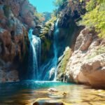 Scenic view of Tahquitz Falls Palm Springs with clear pool and desert cliffs.