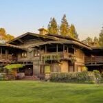 The Gamble House Pasadena historic landmark surrounded by green lawn and trees.