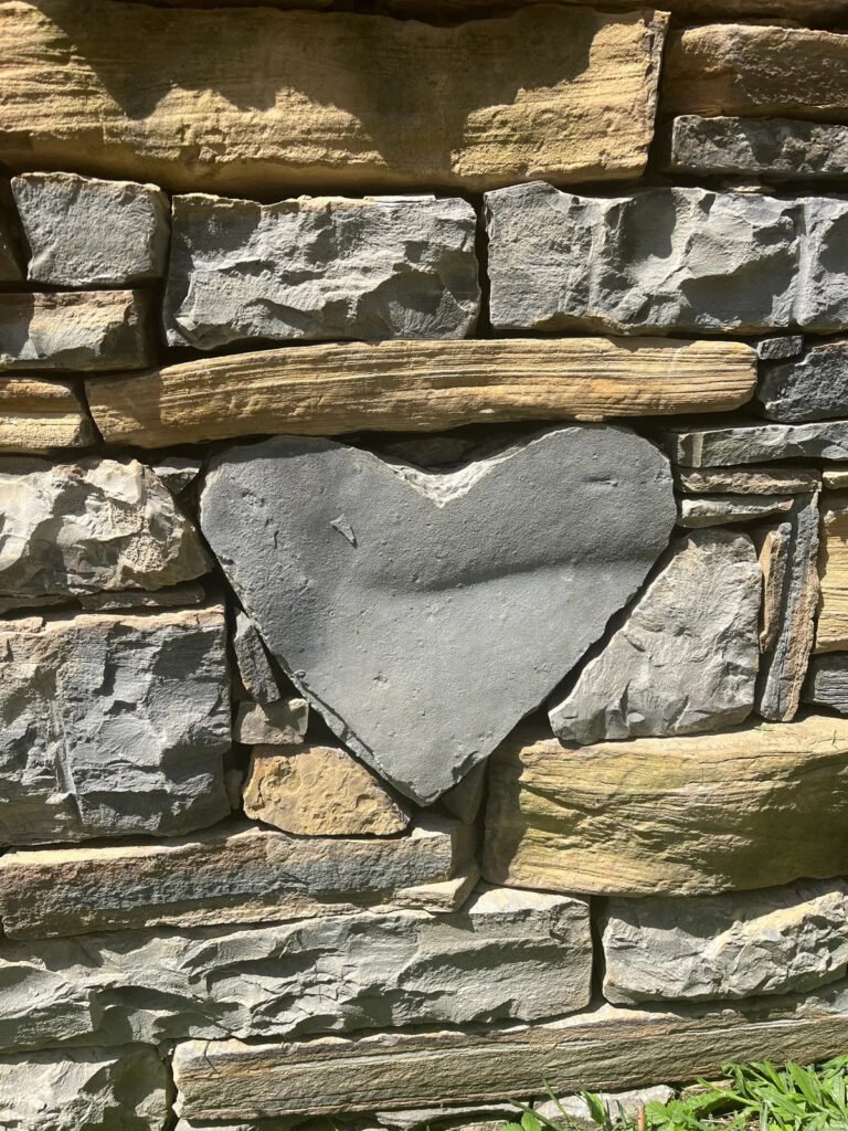 Close-up of a natural heart-shaped stone set in a Nashville rock wall.