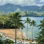 View of 1 Hotel Hanalei Bay in Kauai, one of the top eco-friendly hotels in Hawaii, overlooking the ocean and lush green mountains.