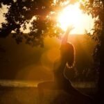 Woman meditating at sunrise during a Palm Springs wellness retreat