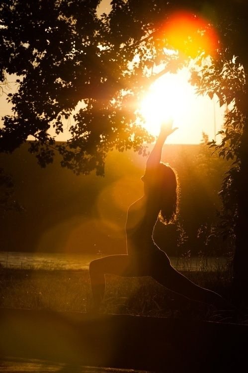 Woman meditating at sunrise during a Palm Springs wellness retreat