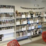 Modern shelves at the Denver Zine Library displaying categorized zines in the Bob Ragland Branch.