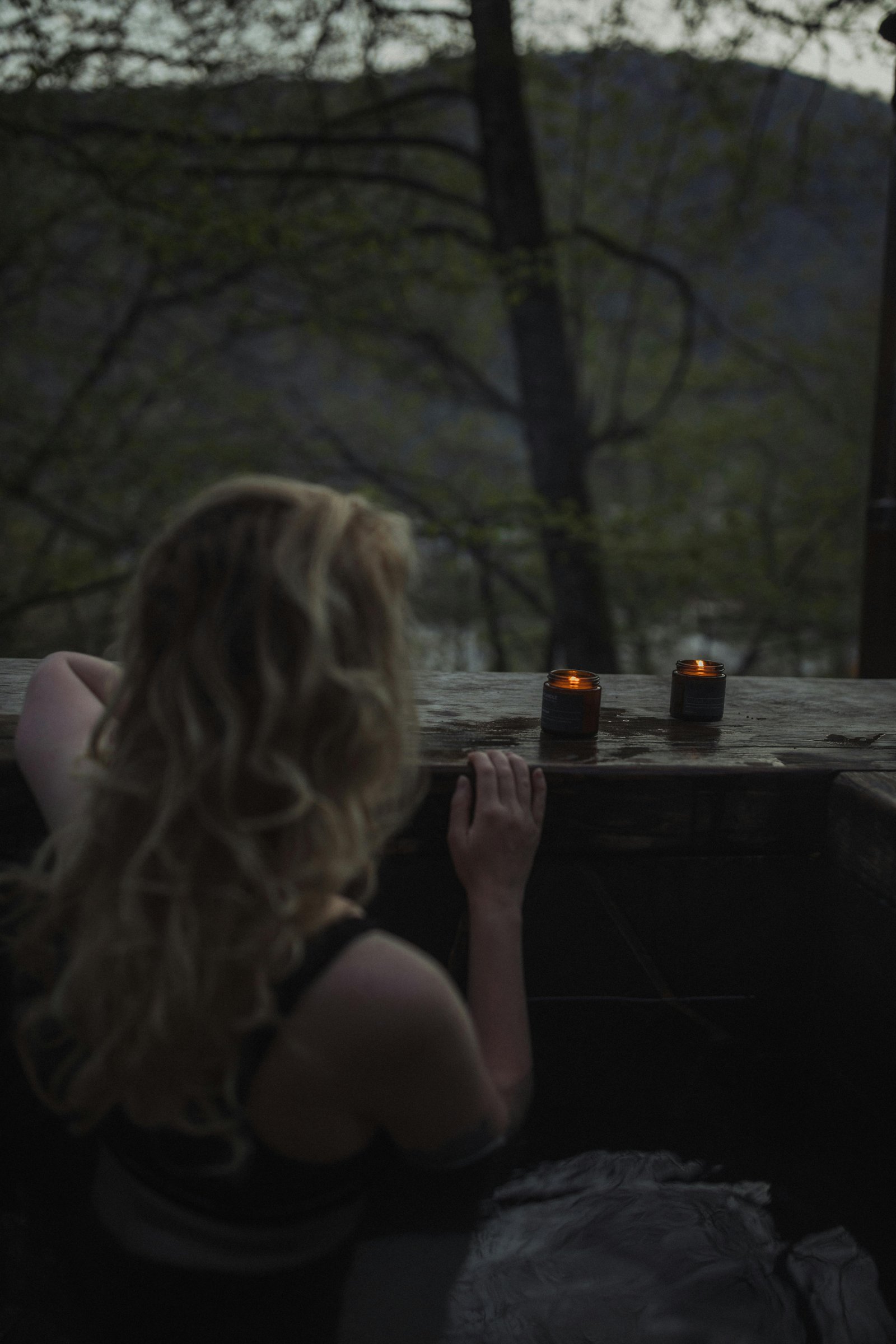 Relaxing Colorado wellness escape with woman soaking in an outdoor hot tub surrounded by nature.