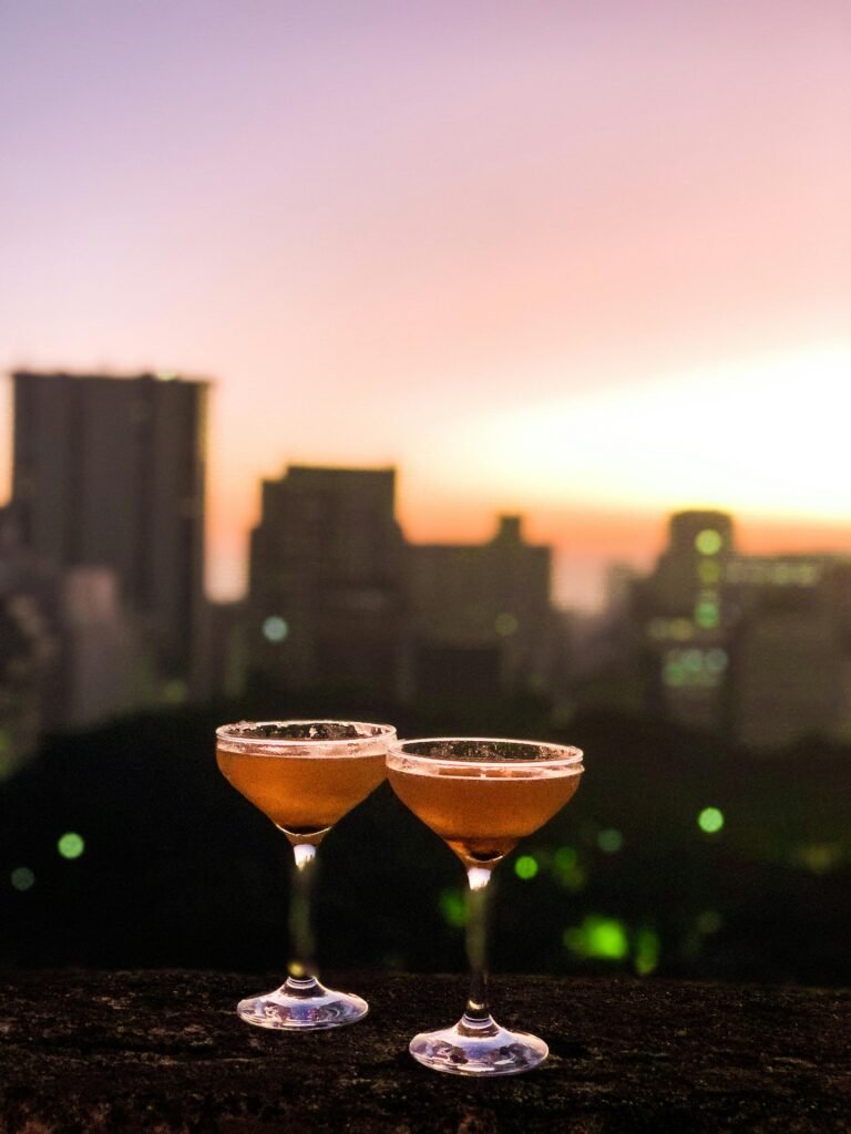 Sunset cocktails on a rooftop with skyline views from one of the best rooftop bars in Nashville.